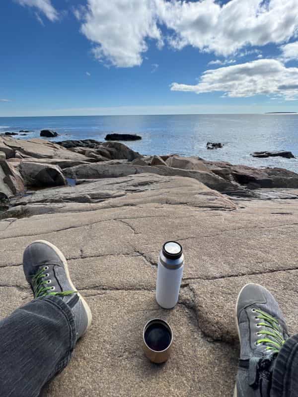 It's okay to be like a child - introspective thoughts on a road trip - coffee thermos on a rock view of ocean