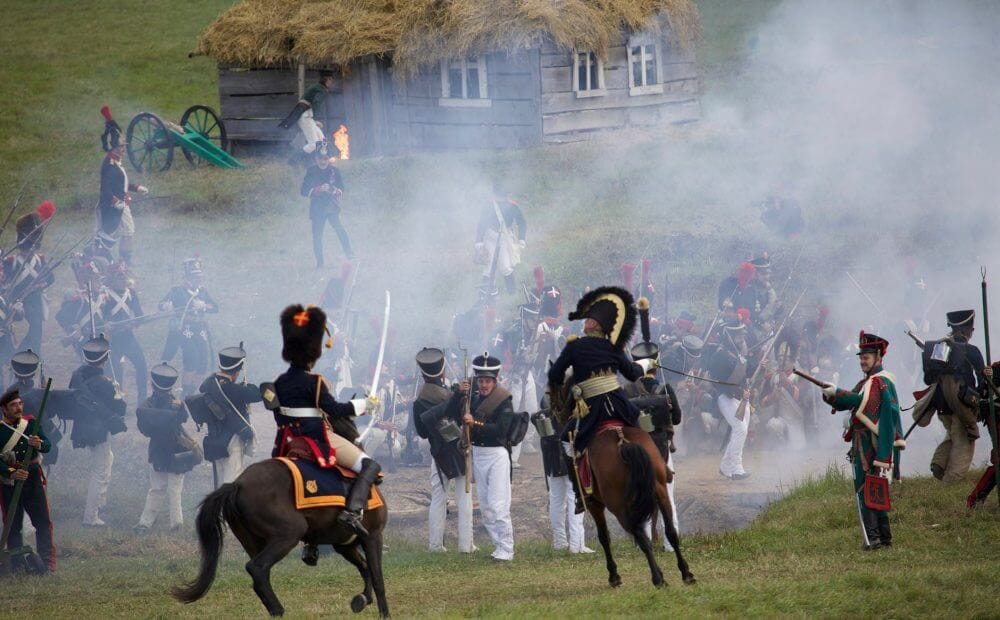 soldiers in historical clothes during reenactment of battle during napoleonic war 