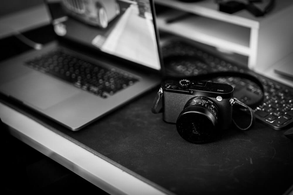 black range finder camera on black table