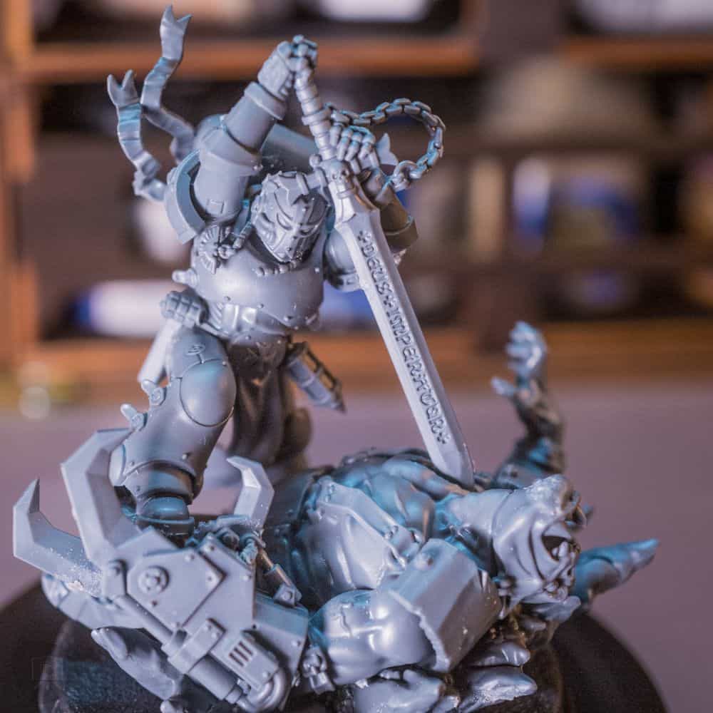 Redgrass games desk lamp review, redgrass games lamp review for painting miniatures, models, and art - Close up of an unpainted Warhammer 40k space marine model killing an ork