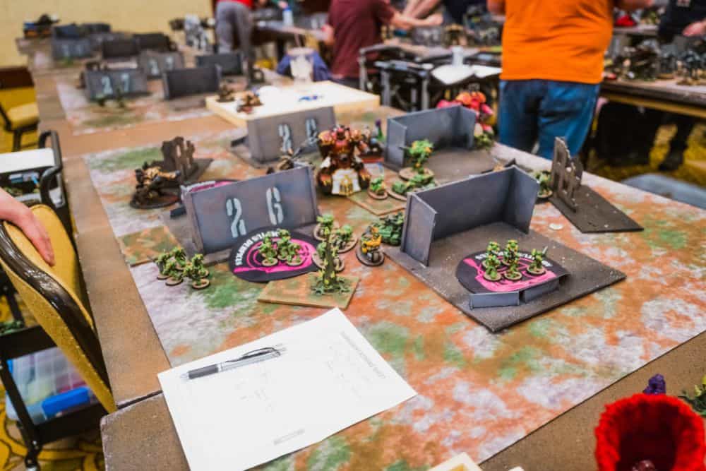 AI Enhanced Wargaming and Tabletop RPGs (Tips and Uses) - The mundane terrain setup of a Warhammer 40k game with orks and space marines on the table