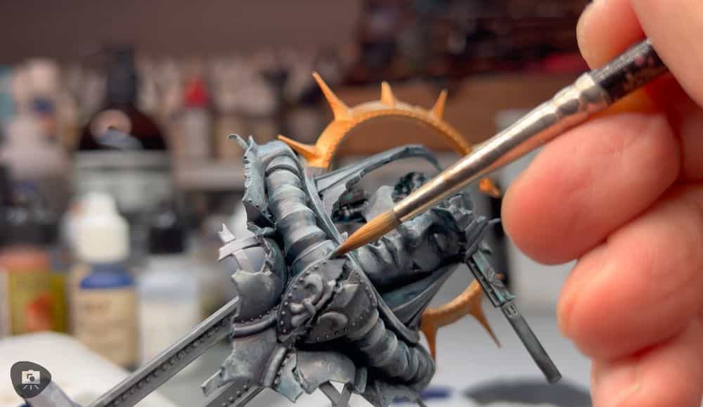 How to Paint Plastic Miniatures (Step-by-Step) - painting plastic miniatures and models -Close up of a brush on a plastic warhammer 40k model