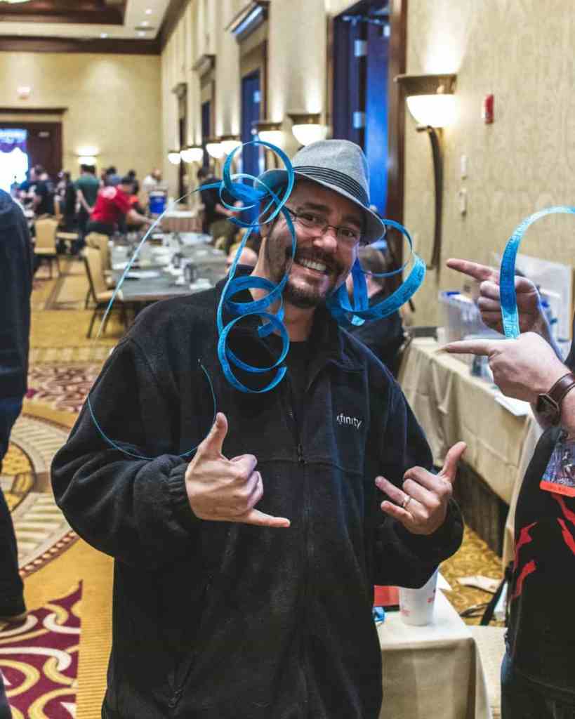 Running a Successful Hobby Gaming Convention: The Hidden Magic and Mayhem Behind CaptainCon - raffle tickets on head of gamer