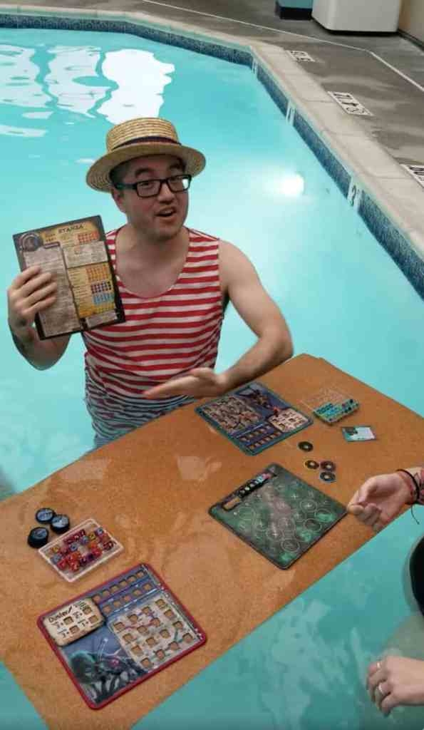 Running a Successful Hobby Gaming Convention: The Hidden Magic and Mayhem Behind CaptainCon - Seppy demonstrating waterproof nature of board game
