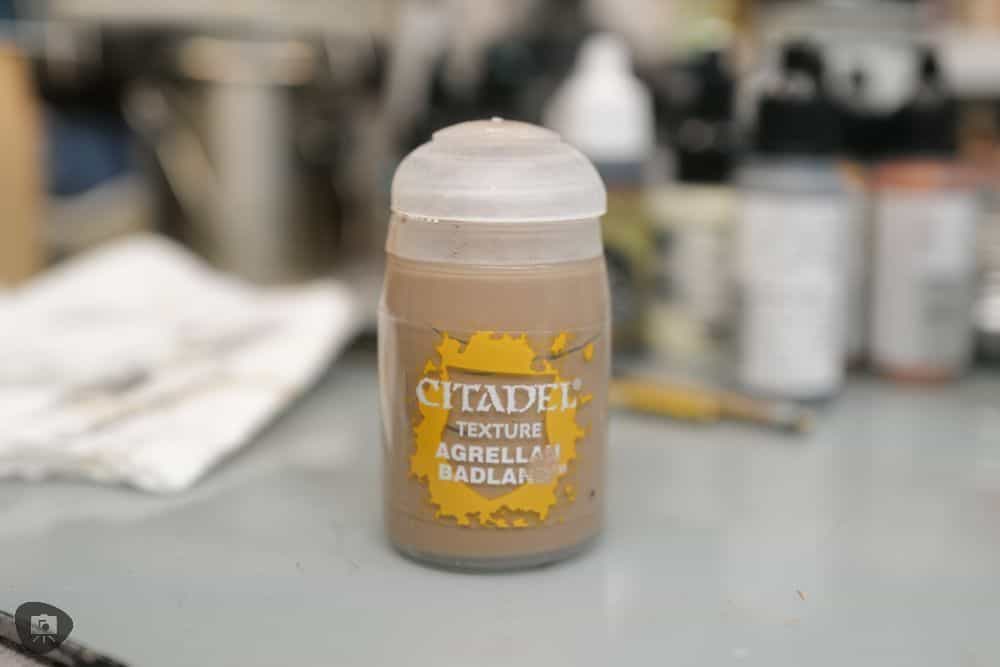 My Favorite Citadel Technical Paint and How to Use Astrogranite Debris (Review) - citadel texture paint astrogranite review and tutorial - Texture paint pot on hobby desk agrellan badland used