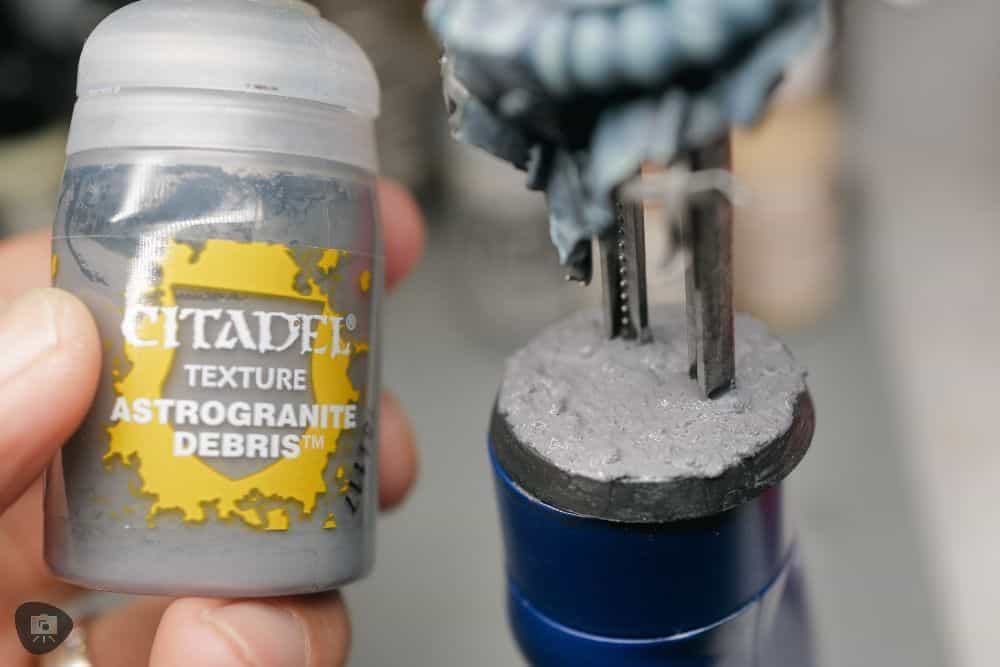 My Favorite Citadel Technical Paint and How to Use Astrogranite Debris (Review) - citadel texture paint astrogranite review and tutorial - Holding a pot of texture astrogranite debris 
