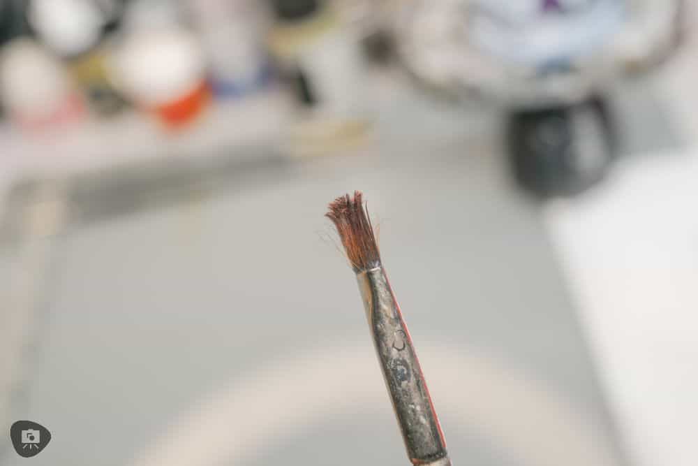 Miniature Paint Brush Care Tutorial - how to care for brushes for miniature painting - Close up photo of a worn out paint brush for painting miniatures