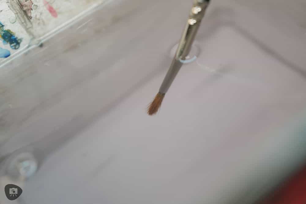 Miniature Paint Brush Care Tutorial - how to care for brushes for miniature painting - rinsing off paint brush bristles in pot of water
