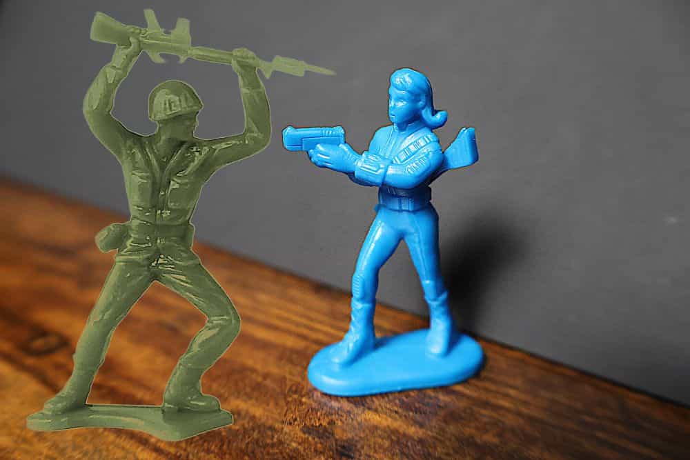 Battle-Ready: Fallout Miniatures Review - Fallout Game Plastic Miniatures set - Female vault dweller blue plastic miniature with green army men model for comparison