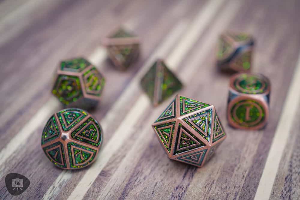 Best DND dice sets for TTRPGs - metal copper dice with sparkling green inlay