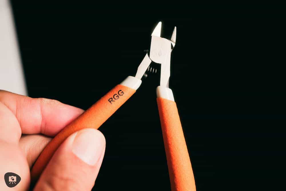 RGG precision nipper with orange textured handle and Redgrassgames logo in black ink on it