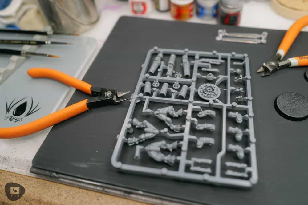Tau plastic model kit on hobby desk with cutters laying nearby