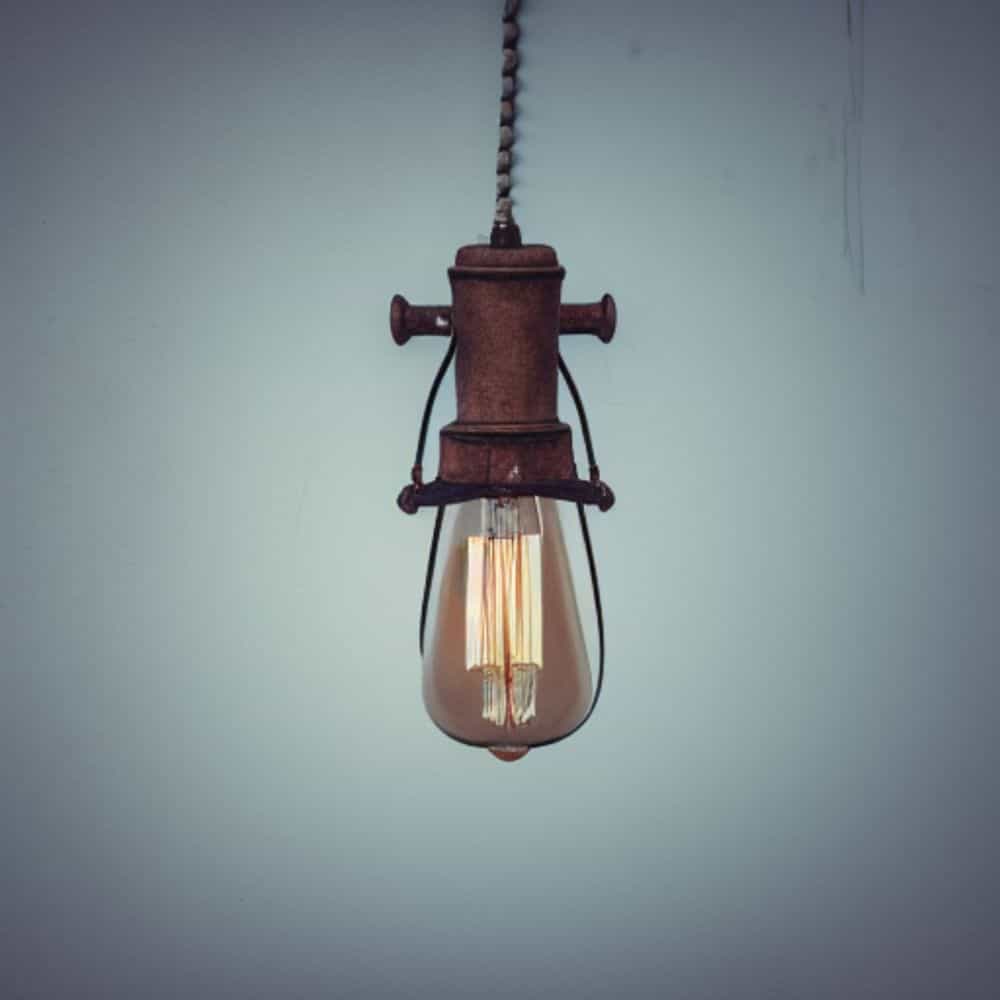 How to Build Emotional Resilience Against Judgement (Editorial) - a vintage light bulb hanging from the ceiling close up 