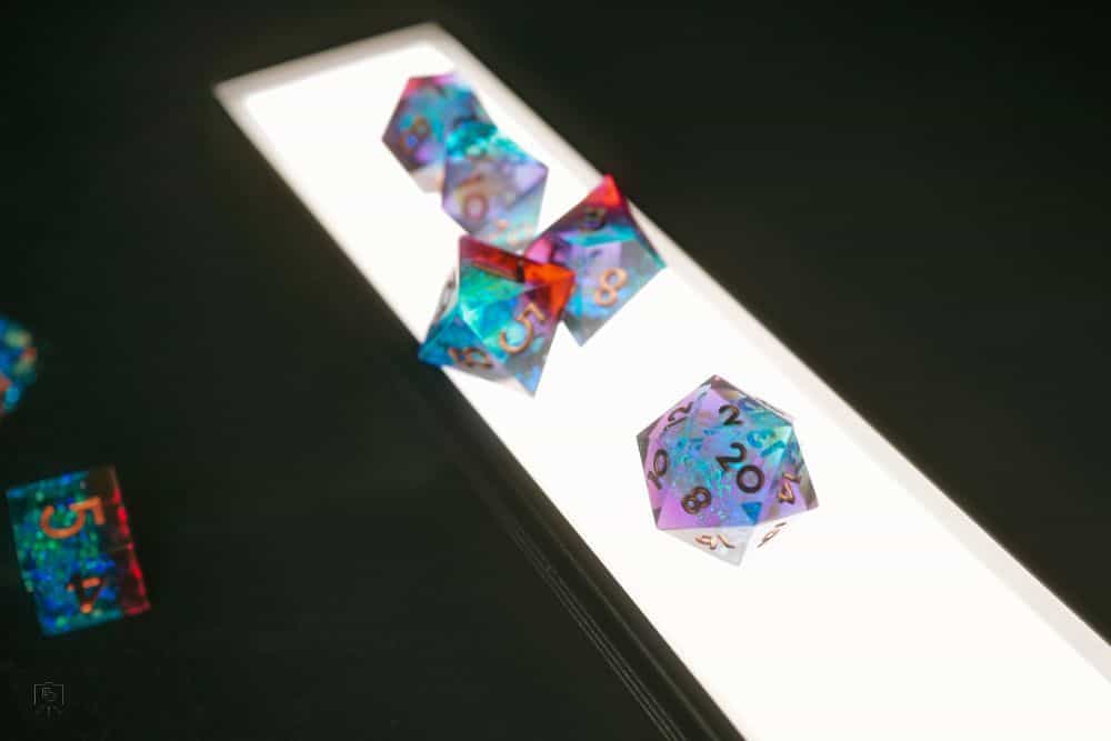 Lume Cube Flex Light Pro: A Review for Hobbyists and Creatives - TTRPG dice sets on top of the LED panel backlit creative image