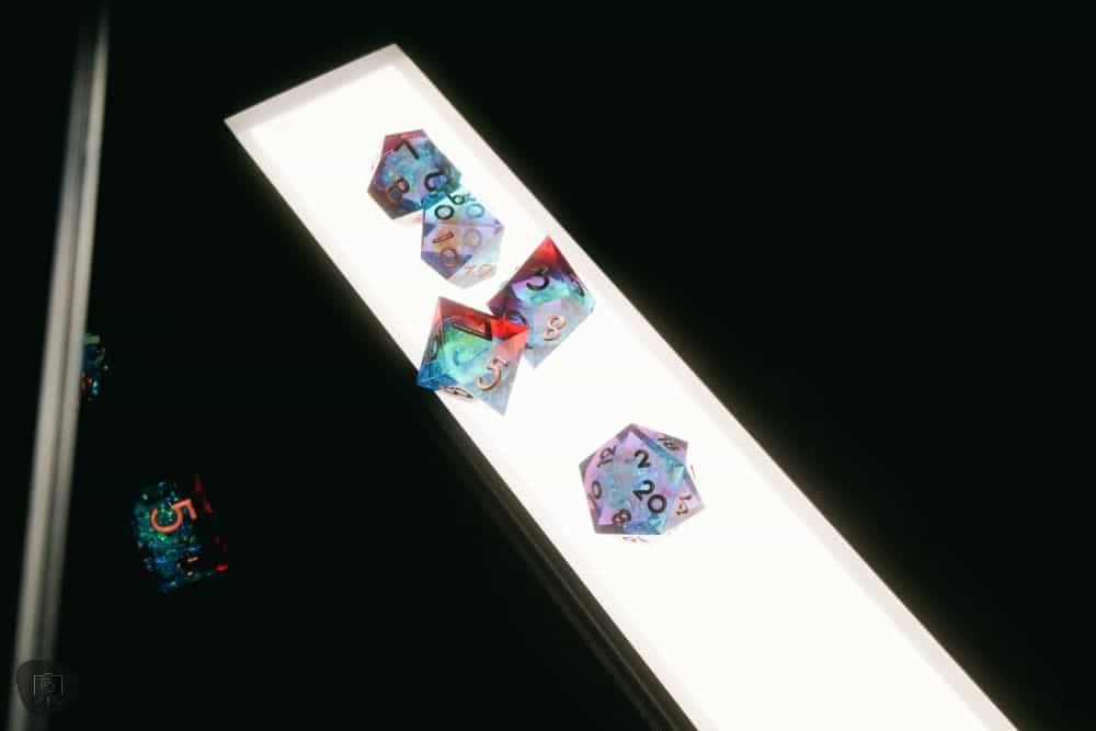 Colorful clear resin acrylic polyhedral dice on the LED panel of the Lume Cube Flex Light Pro 