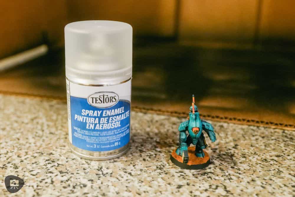 How to Paint Plastic Miniatures (Step-by-Step) - A can of Testors dullcot next to the final painted miniature