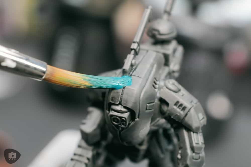 How to Paint Plastic Miniatures (Step-by-Step) - close up photo of applying the first base coat paint layer