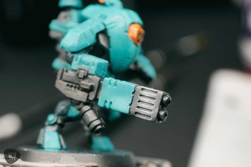 How to Paint Plastic Miniatures (Step-by-Step) - dry brush application on the weapon of a plastic mini