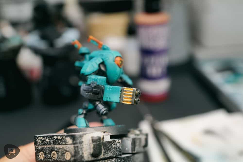 How to Paint Plastic Miniatures (Step-by-Step) - after applying the orange shade over the plasma weapon, creating the final effect