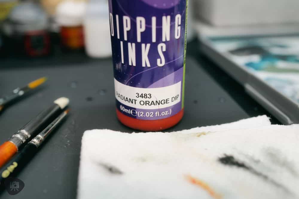 How to Paint Plastic Miniatures (Step-by-Step) - Orange dipping ink as a means to shade and add color to a model's prepainted surface