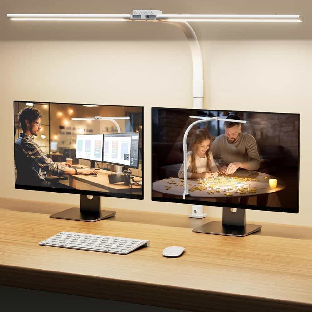 Double-head LED desk lamp mounted behind two computer monitors, casting wide, even workspace lighting for hobbies and office use.
