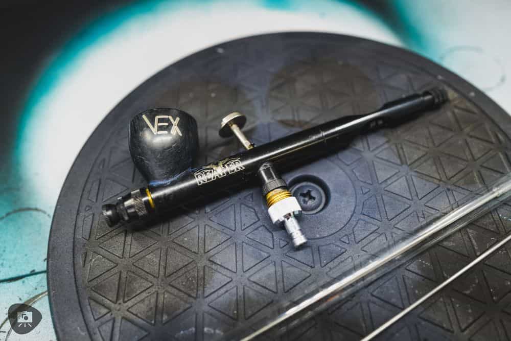 Reaper Vex airbrush review for painting miniatures - airbrush on turntable in spray booth top down photo