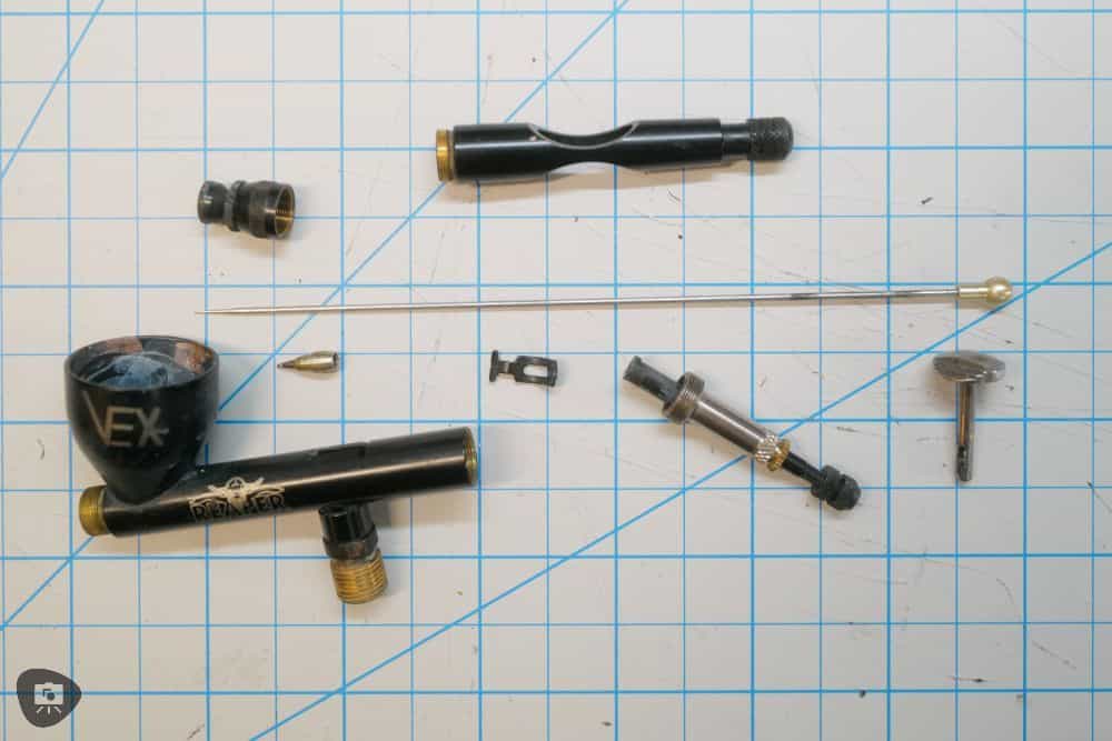 Reaper Vex airbrush review - disassembled Reaper Vex Airbrush parts on grid tabletop mat