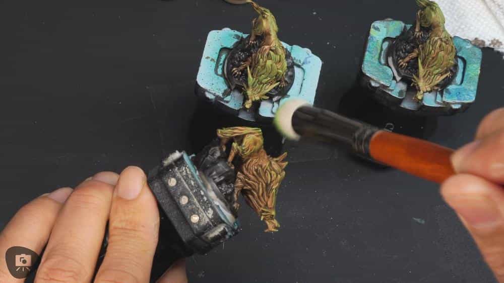 Speed Painting Board Game Miniatures: A Step-by-Step Guide - applying a dry brush green color with a large round brush on miniature