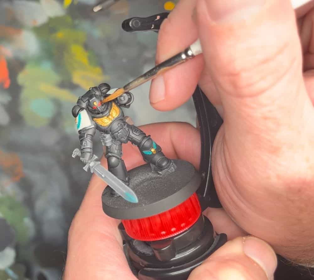 Painting the eye lenses of space marine with the stability bar helping
