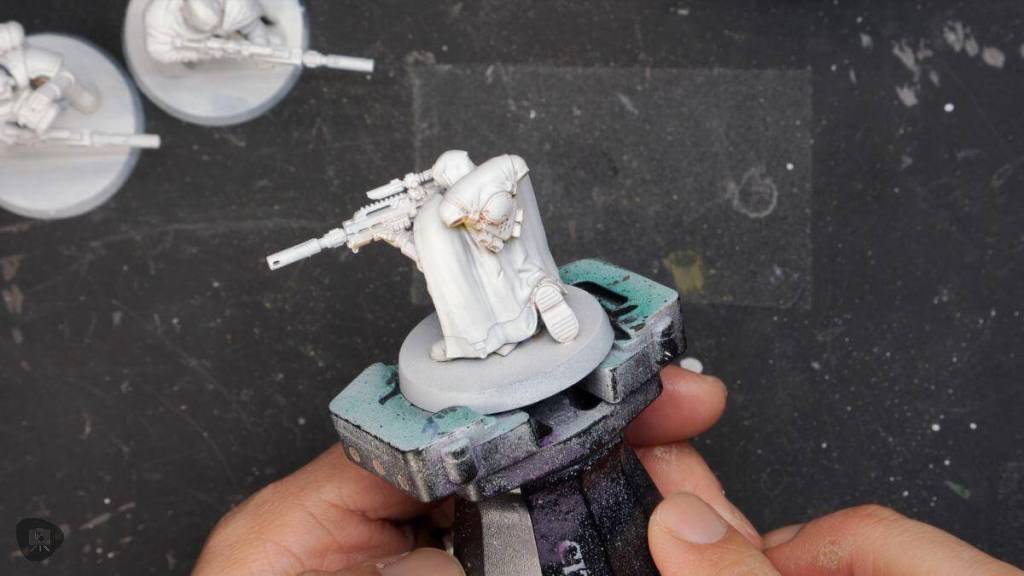 How to paint black on miniatures - tips steps - white primed model space marine on a citadel painting handle