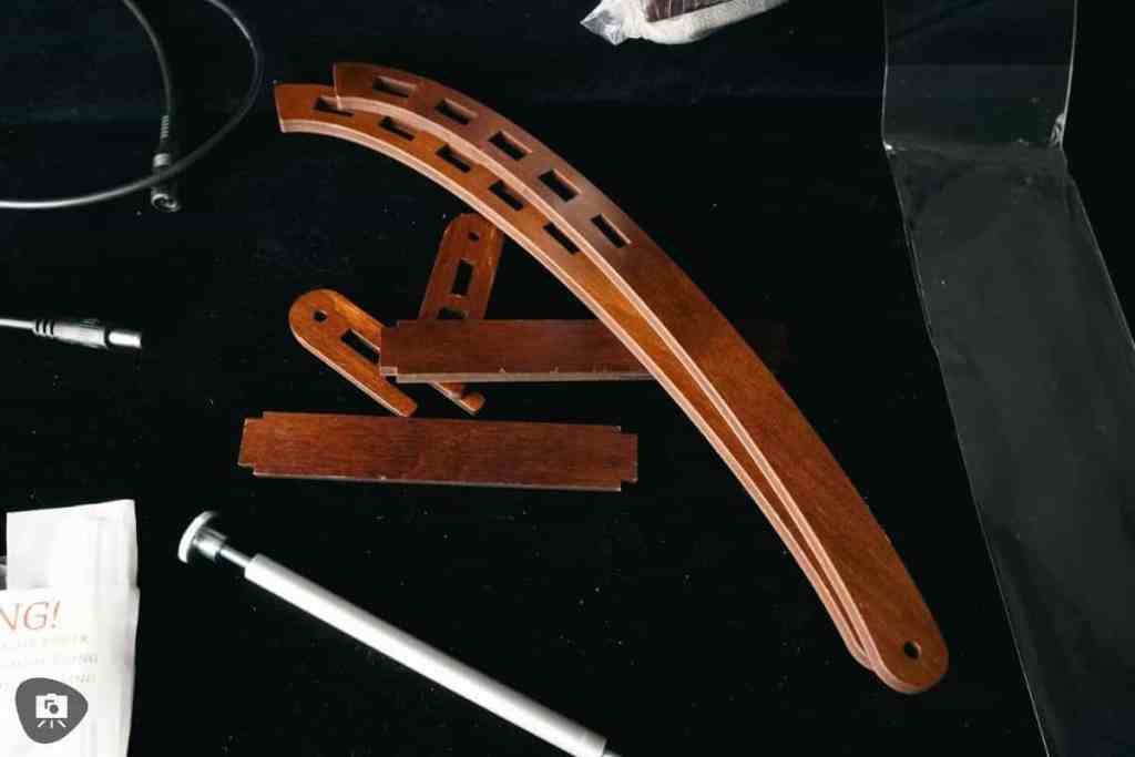 Frontier Wargaming The Hobby Deck Review - portable hobby workstation - Unassembled parts strewn on a black tabletop