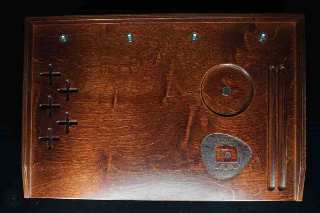 Frontier Wargaming The Hobby Deck Review - portable hobby workstation - The metal mug slot for the hobby deck with wood grain and tangible day logo