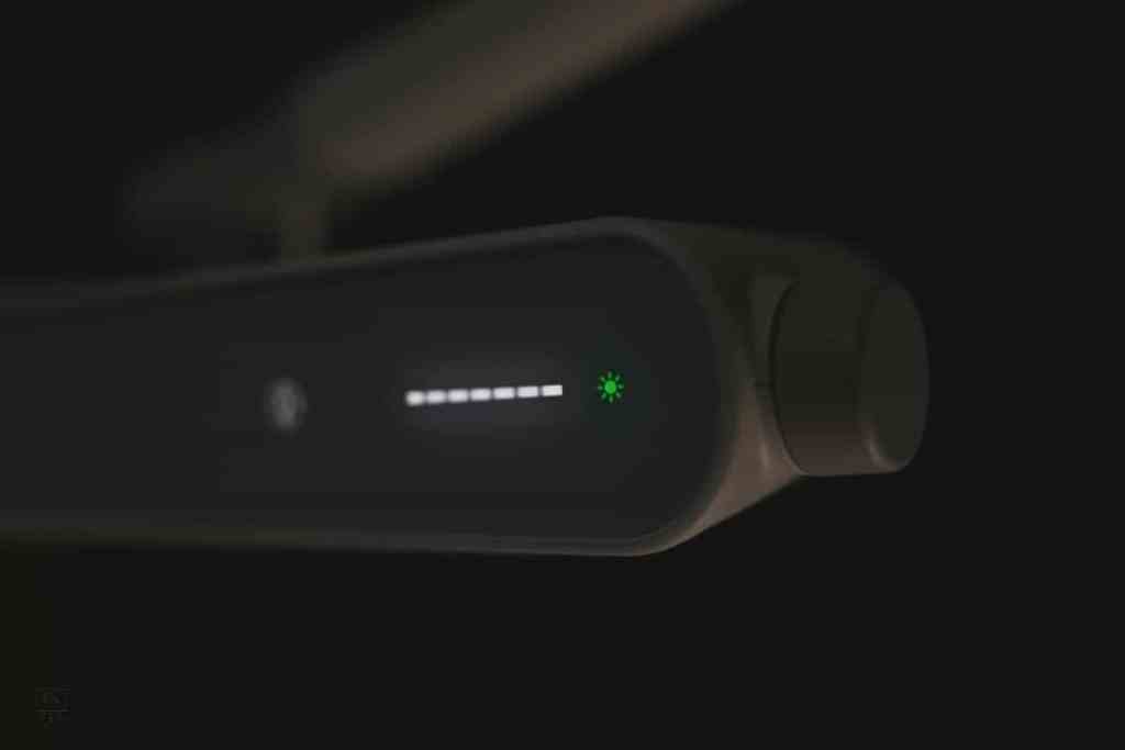 Illuminated brightness control panel of the BenQ MindDuo 2 lamp showing various light levels with a green power indicator.