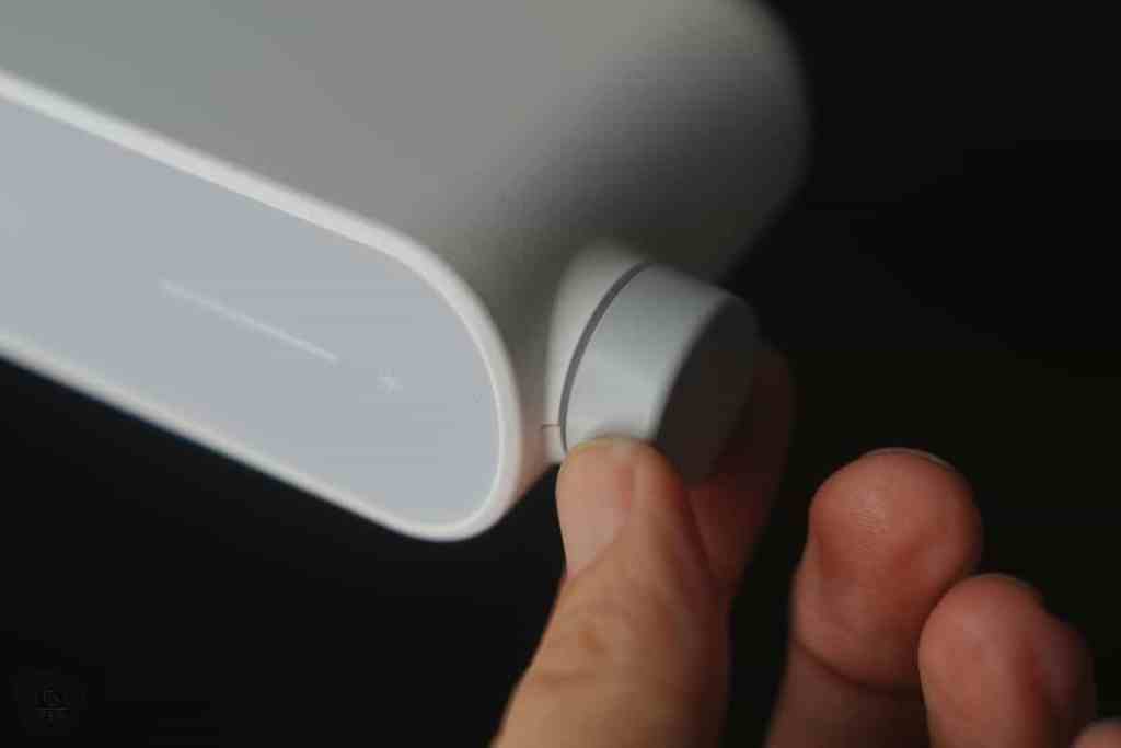 User adjusting the control knob on the BenQ MindDuo 2 desk lamp, illustrating the user-friendly design and functionality