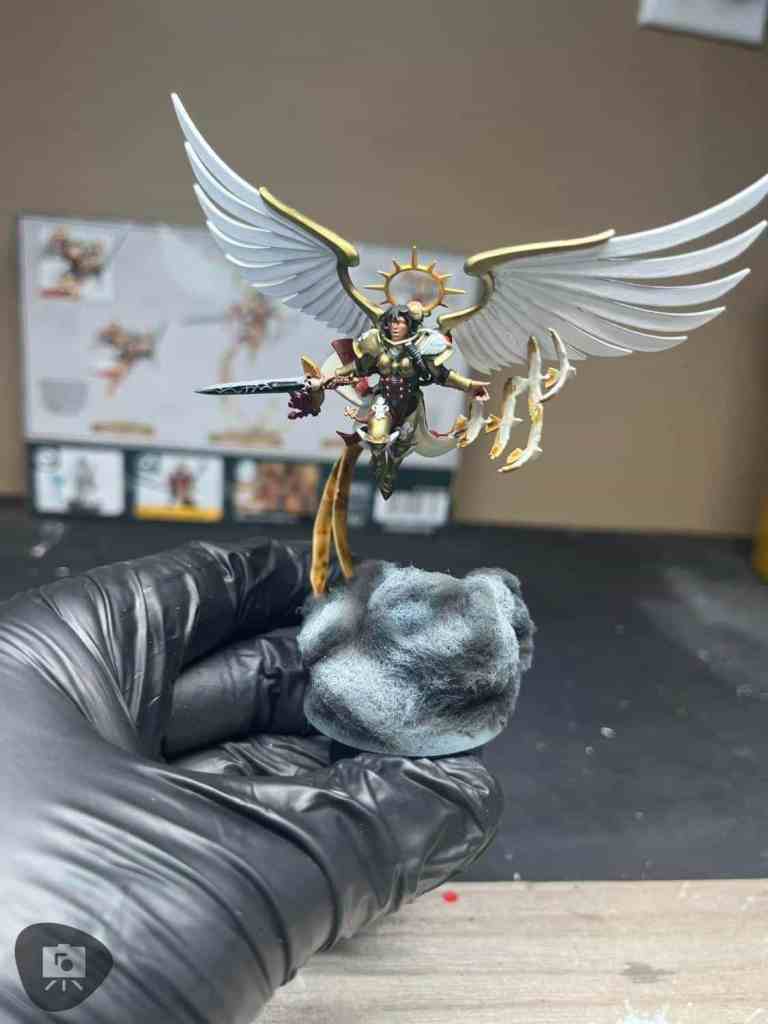 Miniature figure of a winged seraph with a sword and golden armor
