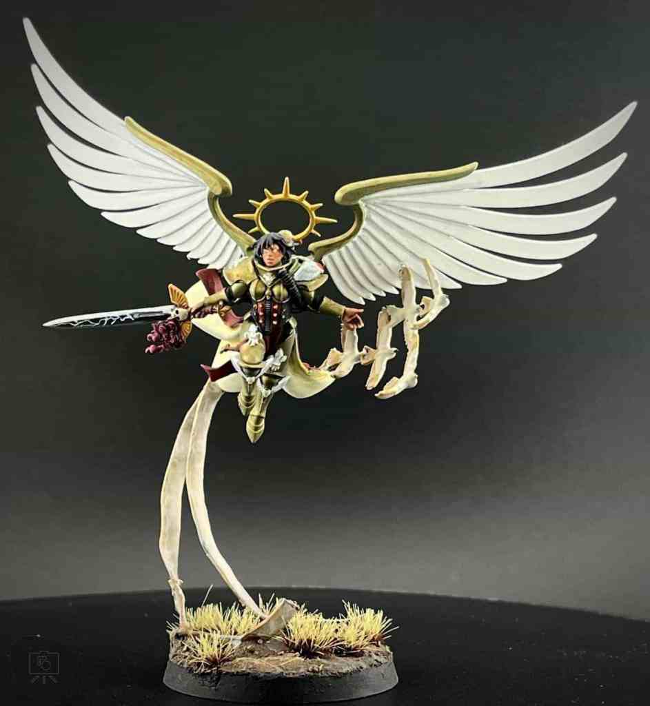 Winged seraph miniature figure on a detailed base with grass