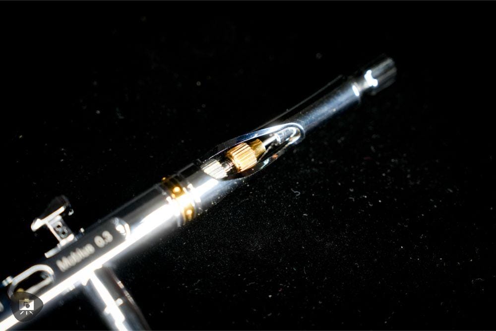 Close-up of the barrel nut and air valve assembly on the Gaahleri airbrush.
