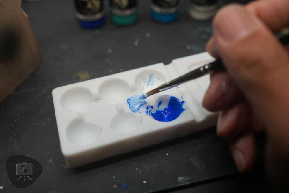 mixing paint on white silicone palette