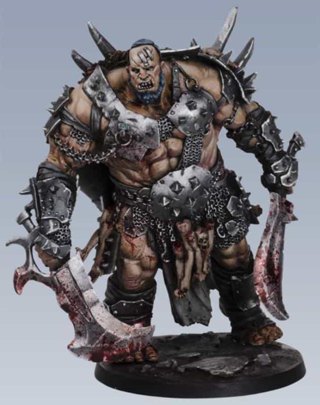 A heavily armored ogre-like warrior with pale skin, spiked black armor, and two bloodstained cleavers, shown as a painting reference for grimdark Ork and fantasy miniature color schemes.