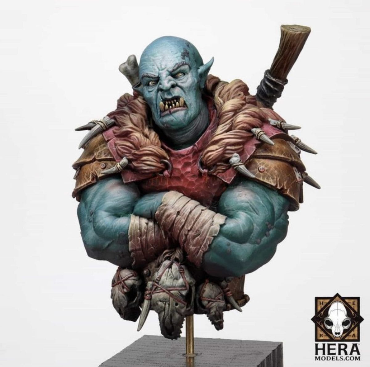 Highly detailed blue-skinned Ork bust with fur-lined armor, crossed arms, and snarling expression—miniature painting reference