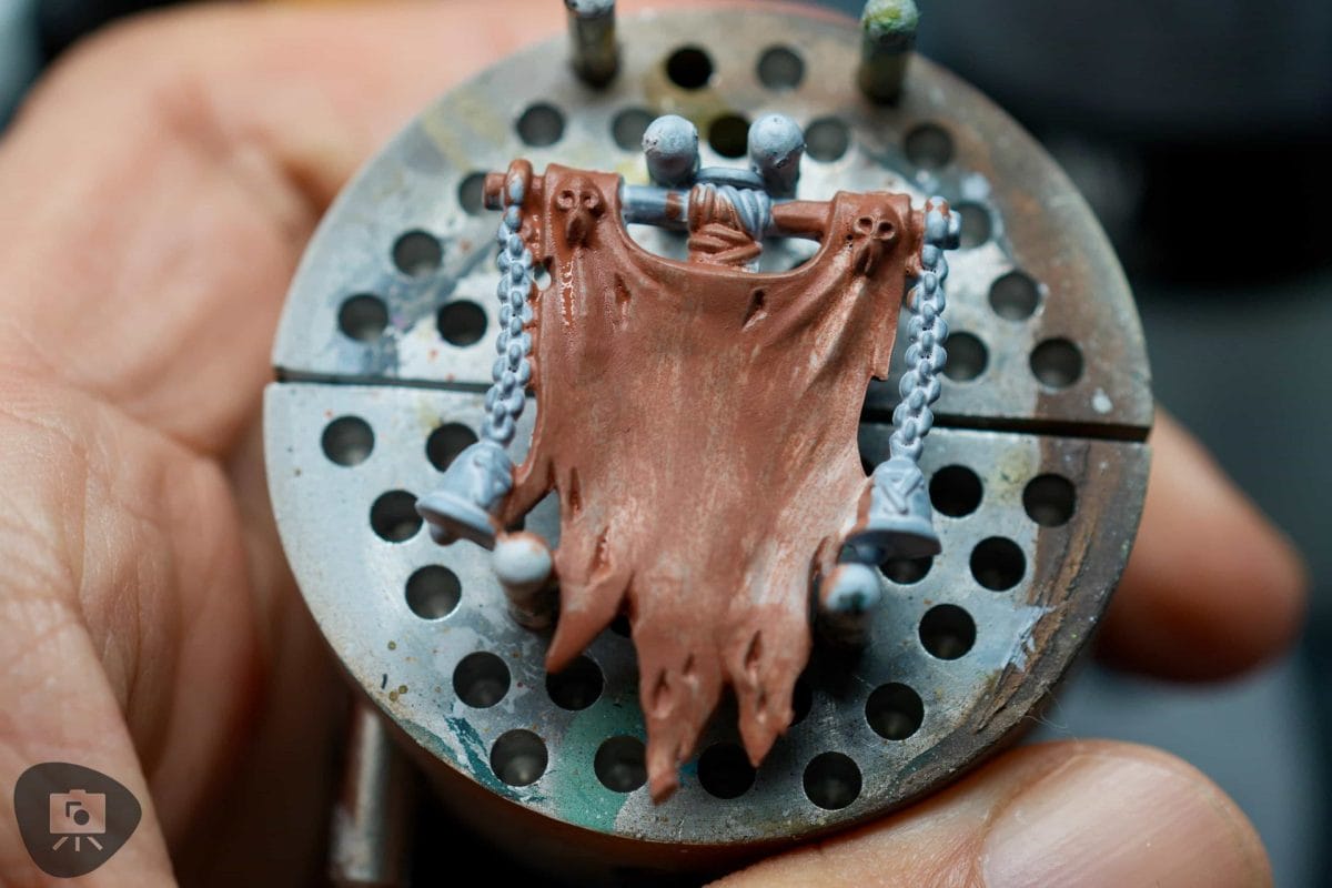 Single thin basecoat layer applied evenly across a miniature surface